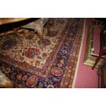 A large Persian machine woven cream ground rug,