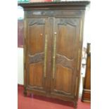 A large early 19th century French provincial oak double door armoire,