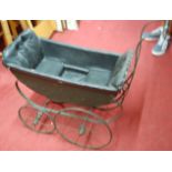 An early 20th century wrought metal and sprung dolls pram