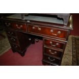 A reproduction mahogany and gilt tooled leather inset twin pedestal writing desk, w.