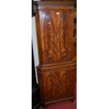 A reproduction mahogany and flame mahogany four door freestanding corner cupboard