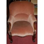 An early Victorian rosewood framed and pink upholstered tub armchair,