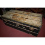 A pine, canvas, and metal bound hinge-top travelling trunk of long proportions, w.