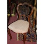 A pair of Victorian walnut balloon back dining chairs,