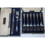 A cased set of six Edwardian silver pastry forks together with one other cased George V silver fork