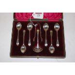 A cased set of six Edwardian silver teaspoons with matching sifting spoon and sugar bows by John