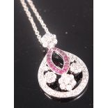 A contemporary ruby and white sapphire set pendant on finelink silver neck chain,