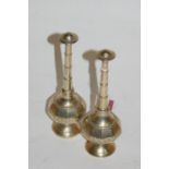 A pair of Eastern base metal pedestal pepperettes