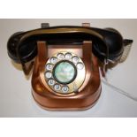 An early 20th century copper cased and bakelite telephone