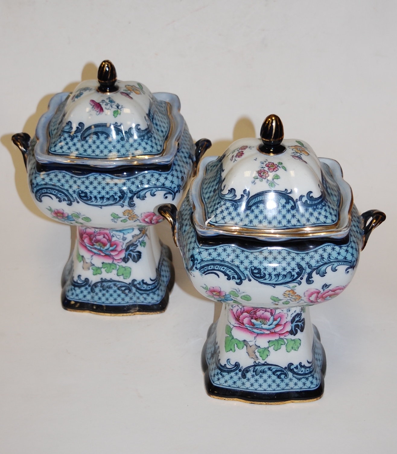 A pair of early 20th century Losolware Wilton pattern pedestal jars and covers,