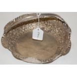 An eastern white metal basket having all over pierced floral decoration and a ropetwist handle