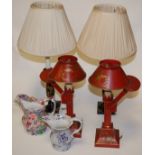 A pair of black lacquered and gilt decorated table lamps;
