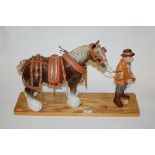 A Markay ceramic figure of a shire horse in full tack, on wooden plinth, h.