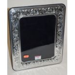 A modern continental silver easel photo frame having a repousse leaf decoration,