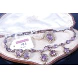 An early 20th century silver gilt and amethyst set necklace in original fitted case together with