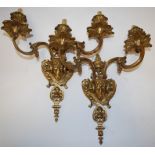 A pair of Egyptian Revival gilt metal twin sconce wall light fittings,