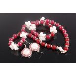 A beaded red hardstone necklace having silver dividers and clasp together with a pair of faux