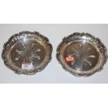 A pair of French silver dishes each having central scrolled sunburst design within scroll and leaf