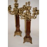 A pair of Rococo style turned beech and gilt metal mounted six sconce table candelabra,