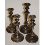 A set of three early 20th century silver plate on copper candlesticks;