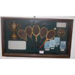 A reproduction framed display of the history of tennis