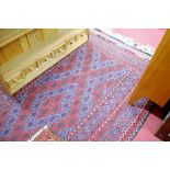 A Persian woollen kilim rug, having a blue and red ground within borders,