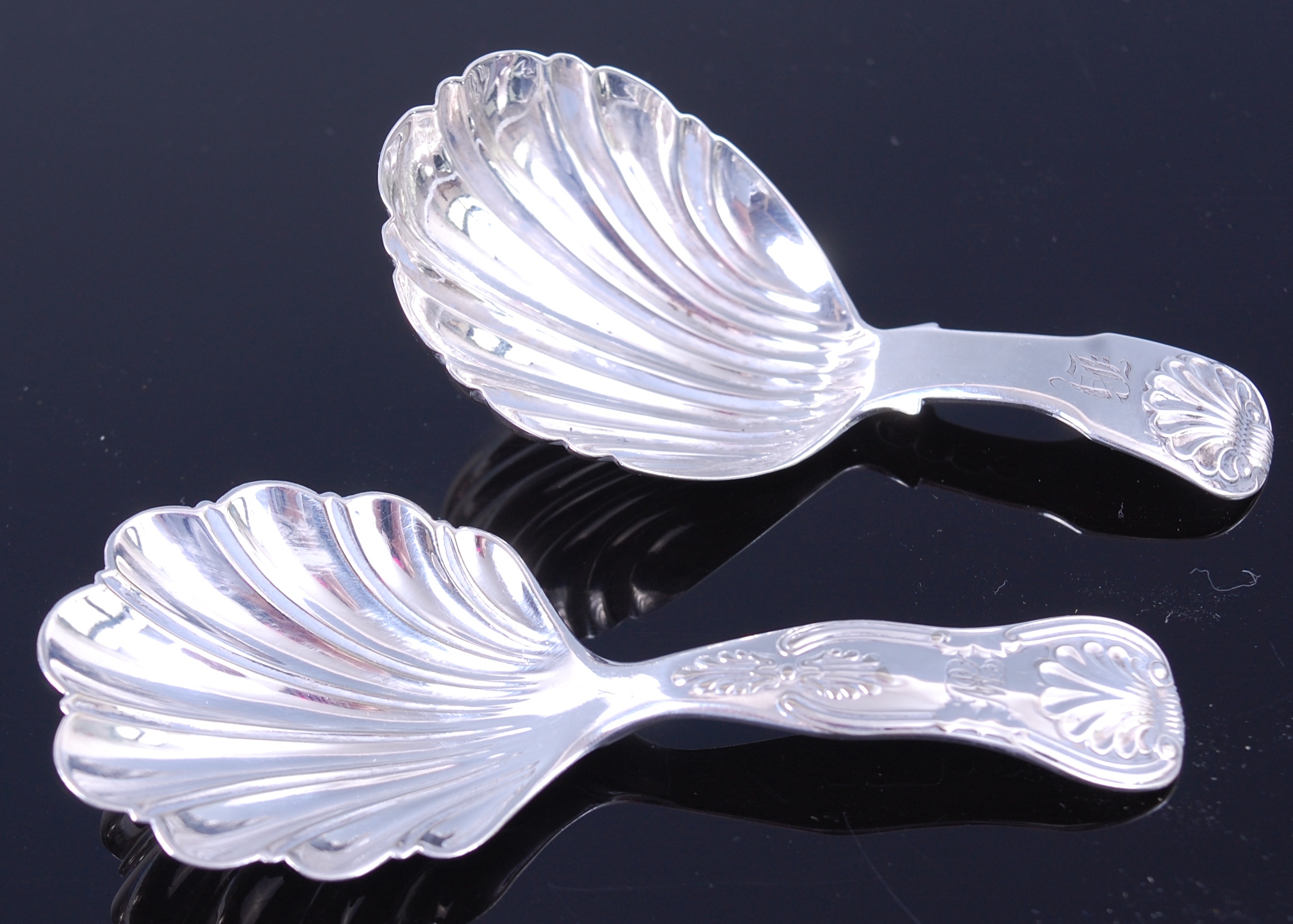 A George IV silver caddy spoon having shell shaped bowl London 1827 together with one other similar