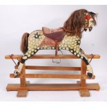 An early 20th century Collinson dapple-grey rocking horse, having horse hair mane and tail,