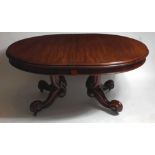 A Victorian mahogany extending dining table, the oval top with moulded edge above plain frieze,