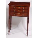 An early 19th century mahogany work table, having three graduated frieze drawers,