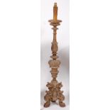 An 18th century Baroque carved and limed softwood alter stick, of good size,