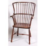A circa 1900 stained beech comb-back farmhouse elbow chair,