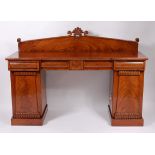 A William IV mahogany twin pedestal sideboard, having three blind frieze drawers,