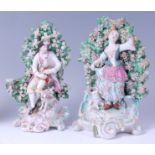 A pair of 18th century Derby porcelain bocage figures, as a bag-piper and shepherdess,