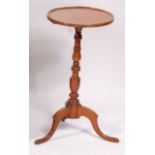 An early 19th century fruitwood and elm pedestal tripod table,
