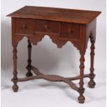 An antique oak lowboy, having three frieze drawers,