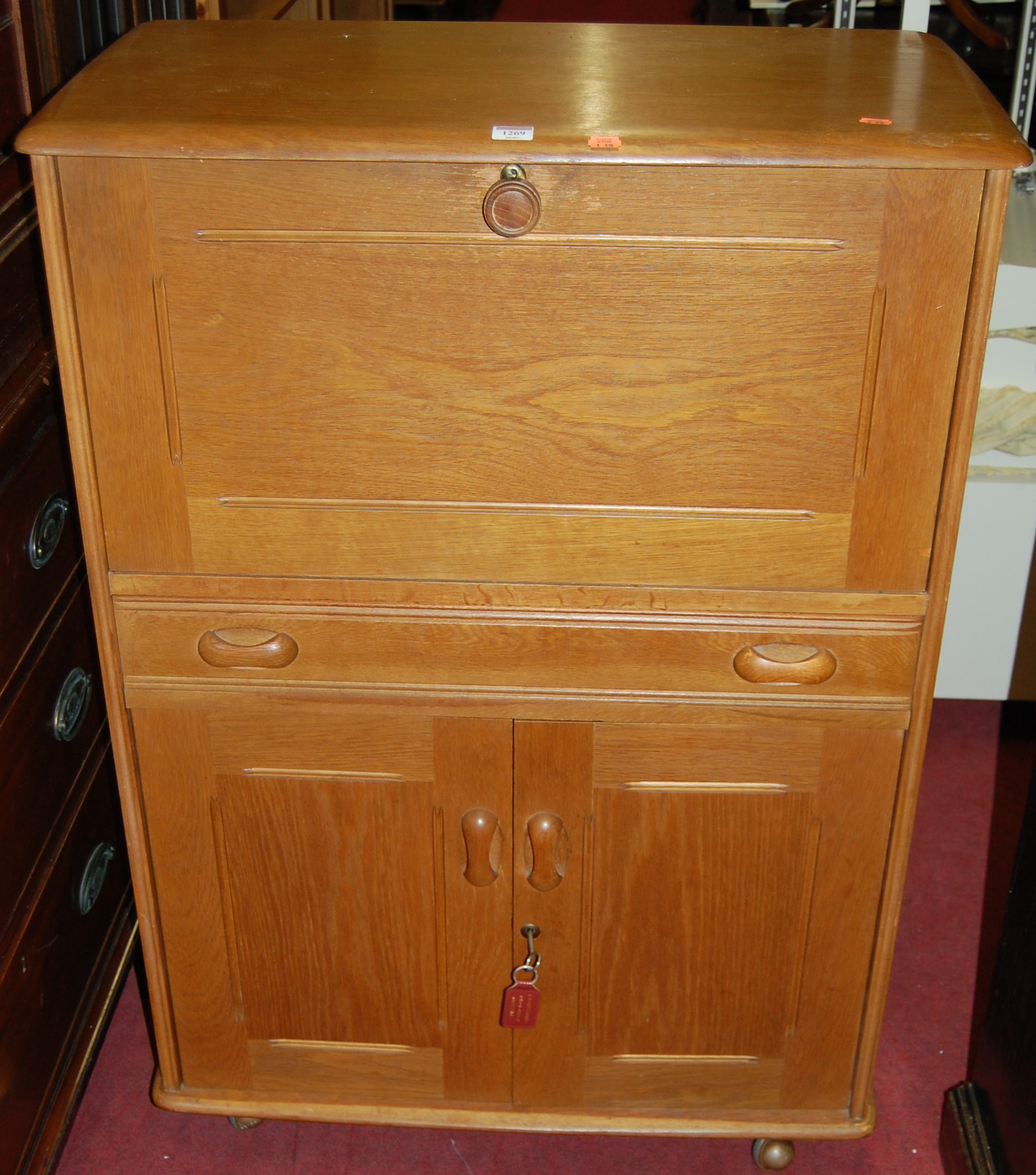 An Ercol blond elm side cabinet,