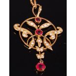 A 1920s 9ct gold, garnet and seed pearl set openwork pendant, 4.