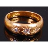 An 18ct gold and diamond gypsy ring, the centre old cut diamond weighing approx. 0.12ct, 5.