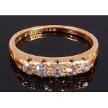 An 18ct gold diamond five stone ring, the graduated old cut diamonds in a chased line setting,