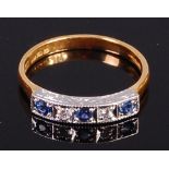 A modern 18ct gold, sapphire and diamond set dress ring arranged as three round cut sapphires,