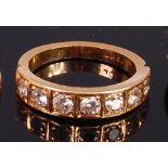 An 18ct gold diamond set half eternity ring arranged as seven illusion set brilliants each weighing