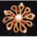 A 1970s 9ct gold, garnet and cultured and seed pearl set flower head brooch, gross weight 10.