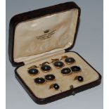 A cased gents 18ct gold backed dress set comprising four buttons, pair cuff links,