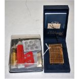 A Du Pont of Paris gilt metal cased pocket cigarette lighter having textured finish in fitted box