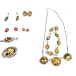 A quantity of amber and hardstone set ear pendants, brooches,