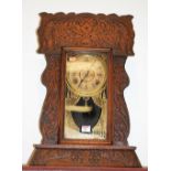 A late 19th century oak cased mantel clock by the Ansonia clock Company,