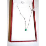 An emerald and diamond set pendant (approx 0.