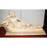 A mid-20th century *cast resin* figure of a semi-nude female in reclining pose, w.