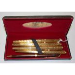 A Parker gilt metal cased fountain pen having 14ct gold nib,